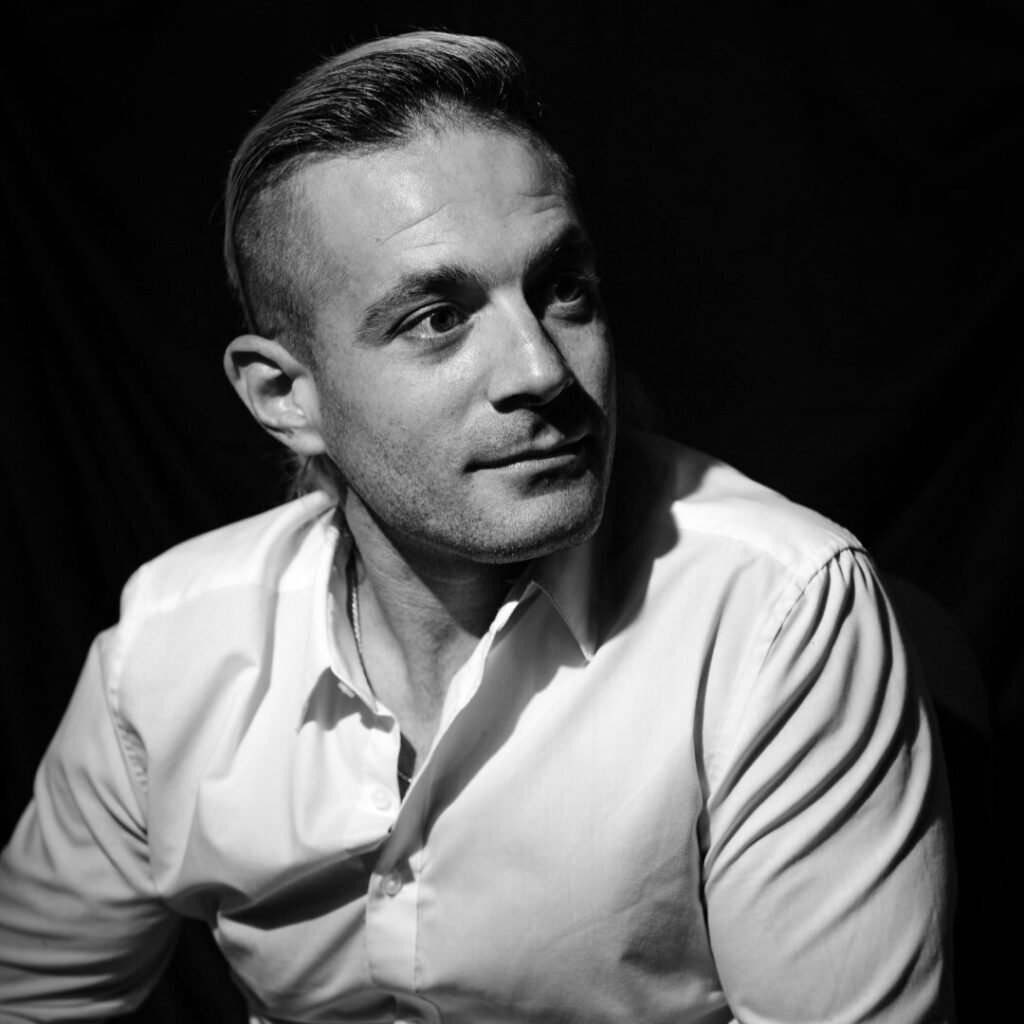 Headshot Eddie Signaigo black and white headshot.