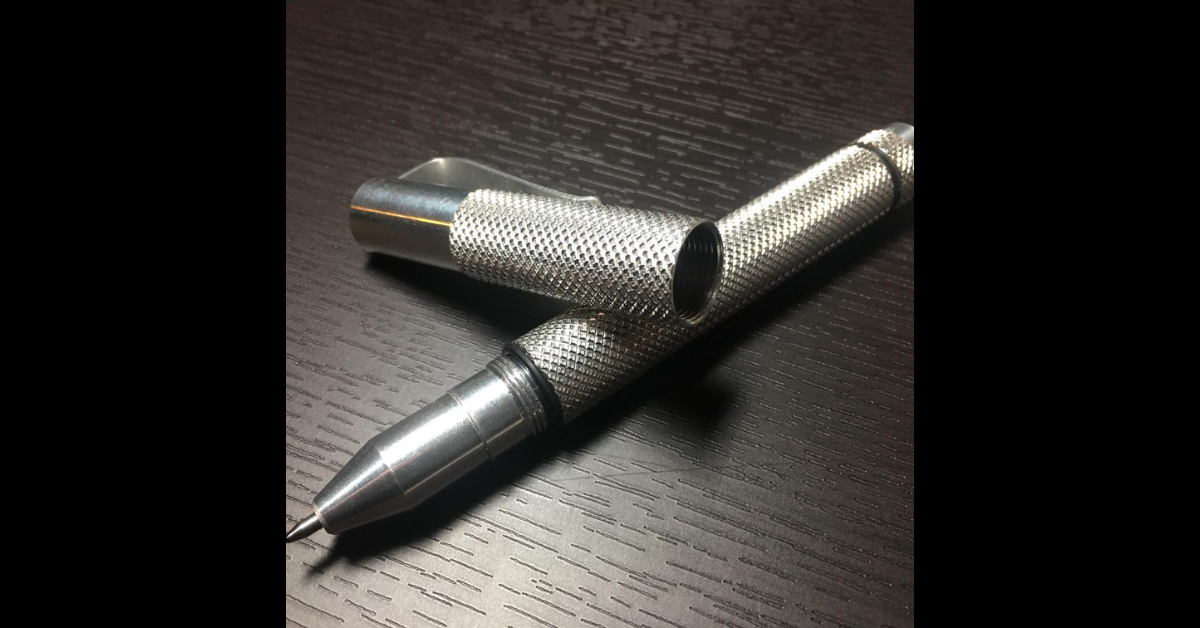 Steel pen on a wooden desk.