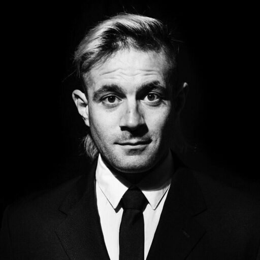 Eddie Signaigo black and white headshot. Eddie Signaigo black and white headshot.