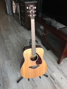 Eddie's Yamaha Acoustic guitar on a guitar stand.
