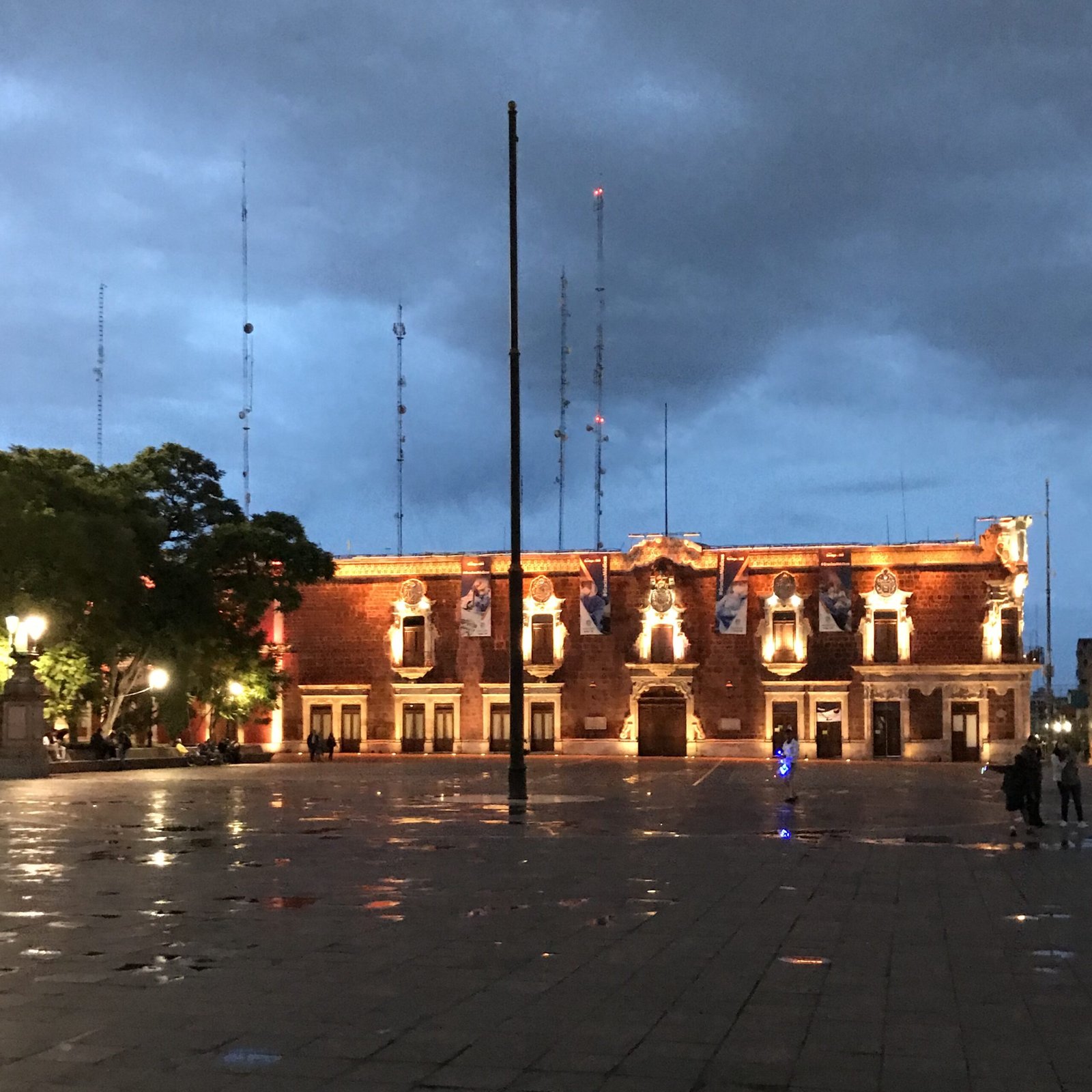 Plaza de la Patria lit up on a rainy evening